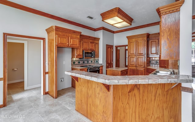 kitchen with kitchen peninsula, decorative backsplash, a breakfast bar, black range, and crown molding