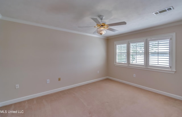 empty room featuring ceiling fan, ornamental molding, and light colored carpet