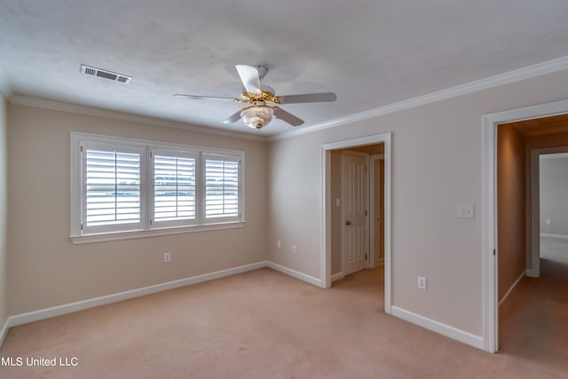 carpeted empty room featuring ceiling fan and crown molding