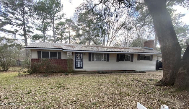 ranch-style home with a front lawn