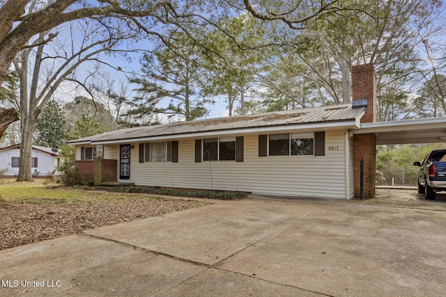 ranch-style house featuring a carport