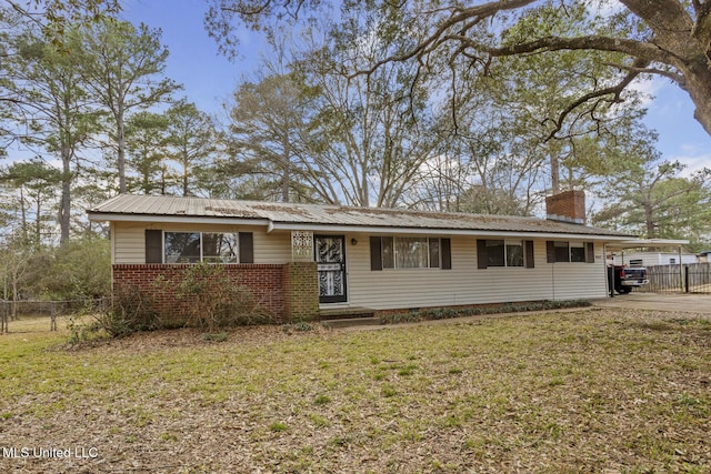 ranch-style home featuring a carport and a front lawn