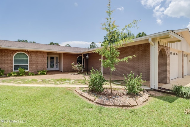 12 Bayou View Dr, Gulfport, MS 39507 - view of front of home featuring a front lawn, french doors, brick siding, and a garage