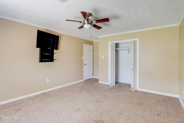 12 Bayou View Dr, Gulfport, MS 39507 - unfurnished bedroom with crown molding, carpet, a closet, a textured ceiling, and a ceiling fan