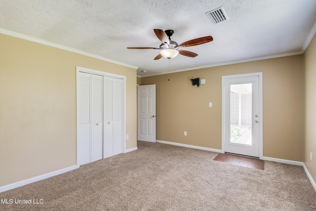 12 Bayou View Dr, Gulfport, MS 39507 - unfurnished bedroom featuring carpet, crown molding, a closet, a textured ceiling, and ceiling fan