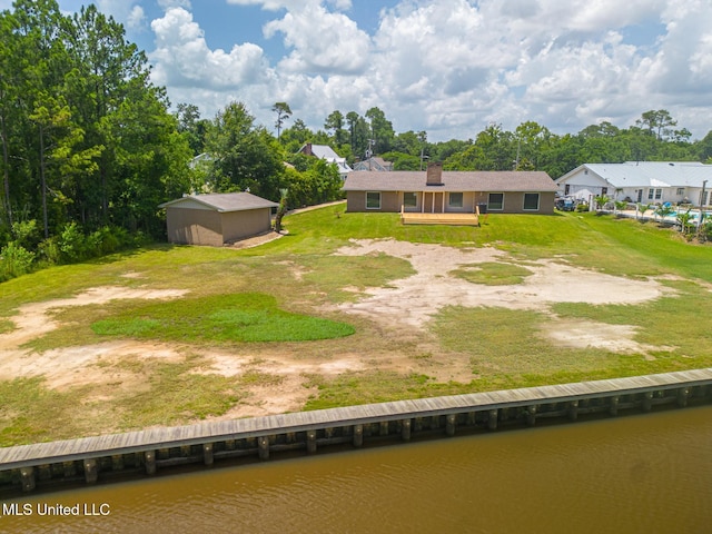 12 Bayou View Dr, Gulfport, MS 39507 - rear view of house with a water view, a chimney, an outbuilding, and a yard