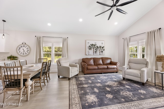 living room with vaulted ceiling, light hardwood / wood-style flooring, and ceiling fan