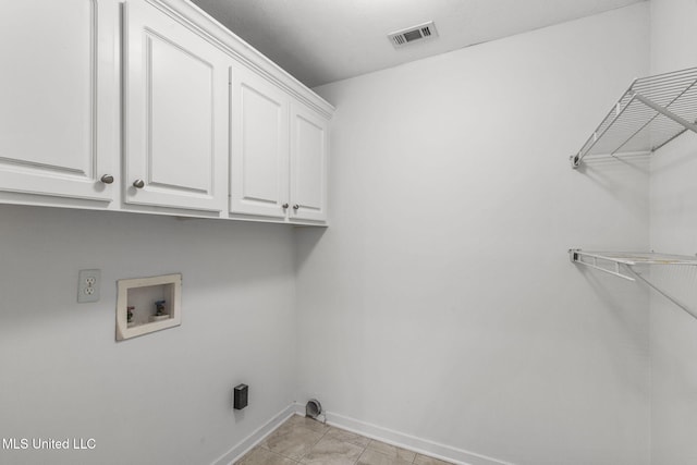 laundry room with washer hookup, cabinet space, visible vents, light tile patterned flooring, and baseboards