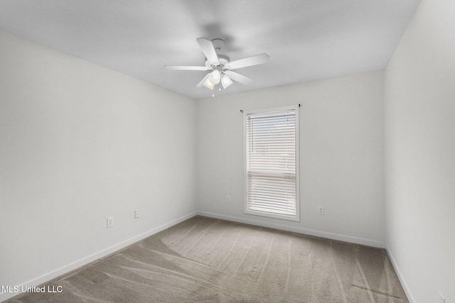 unfurnished room featuring carpet flooring, a ceiling fan, and baseboards