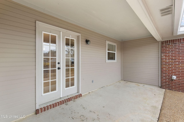 view of patio with french doors and visible vents