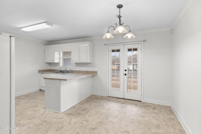 kitchen featuring white cabinets, ornamental molding, a peninsula, white dishwasher, and a sink