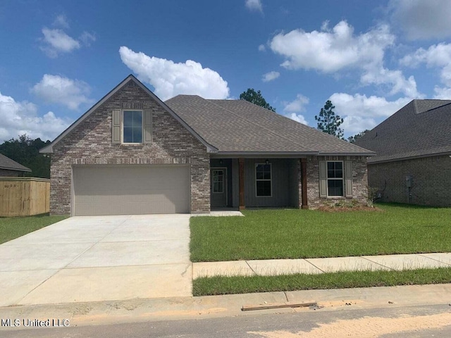 view of front of house featuring a front lawn and a garage