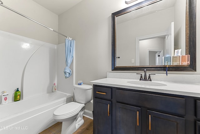 full bathroom featuring toilet, hardwood / wood-style floors, vanity, and shower / bath combo