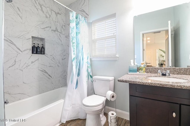 full bathroom featuring hardwood / wood-style flooring, vanity, toilet, and shower / bath combo