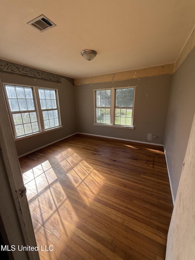 spare room featuring hardwood / wood-style floors