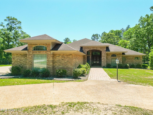41 C G Evans Rd, Wiggins, MS 39577 - view of front of house with brick siding, french doors, roof with shingles, and a front yard