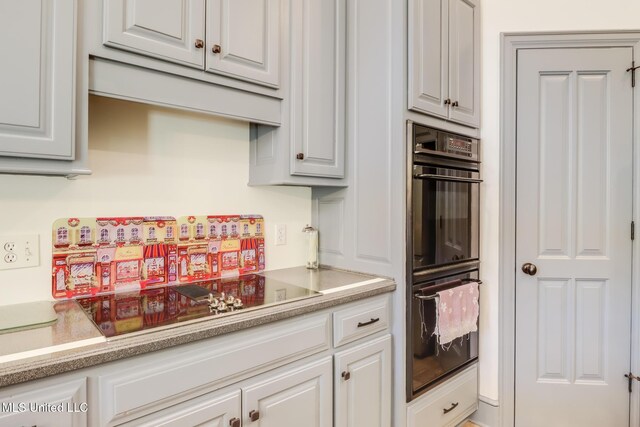 41 C G Evans Rd, Wiggins, MS 39577 - kitchen with light countertops, white cabinetry, and black appliances