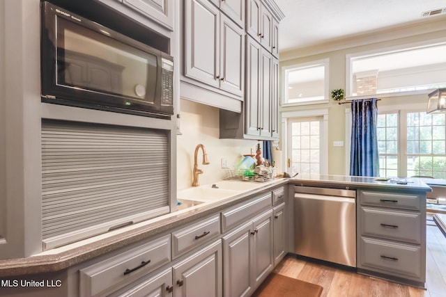 41 C G Evans Rd, Wiggins, MS 39577 - kitchen with stainless steel dishwasher, plenty of natural light, a peninsula, gray cabinetry, and visible vents