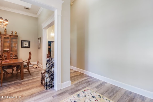 41 C G Evans Rd, Wiggins, MS 39577 - hall with light wood finished floors, visible vents, an inviting chandelier, and crown molding