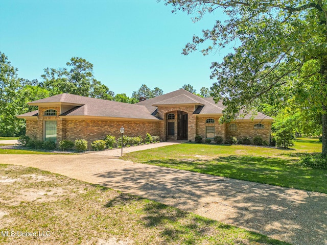 41 C G Evans Rd, Wiggins, MS 39577 - view of front facade featuring brick siding, a shingled roof, and a front lawn