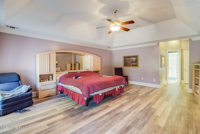 41 C G Evans Rd, Wiggins, MS 39577 - bedroom with a tray ceiling, light wood-type flooring, baseboards, visible vents, and a ceiling fan