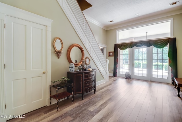 41 C G Evans Rd, Wiggins, MS 39577 - foyer entrance featuring wood finished floors, visible vents, stairs, and ornamental molding