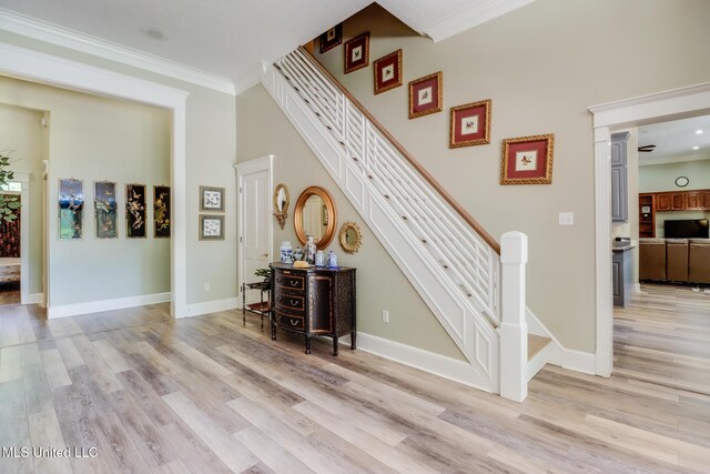 41 C G Evans Rd, Wiggins, MS 39577 - stairs with baseboards, wood finished floors, and ornamental molding