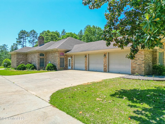 41 C G Evans Rd, Wiggins, MS 39577 - view of front of home with an attached garage, a front lawn, brick siding, and concrete driveway
