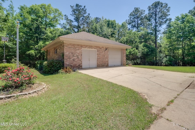 41 C G Evans Rd, Wiggins, MS 39577 - view of side of home with brick siding, a yard, driveway, and a garage