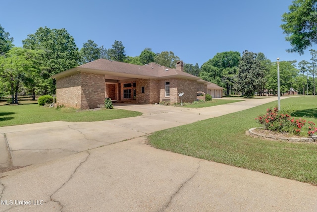 41 C G Evans Rd, Wiggins, MS 39577 - single story home with brick siding, a chimney, a front lawn, and concrete driveway