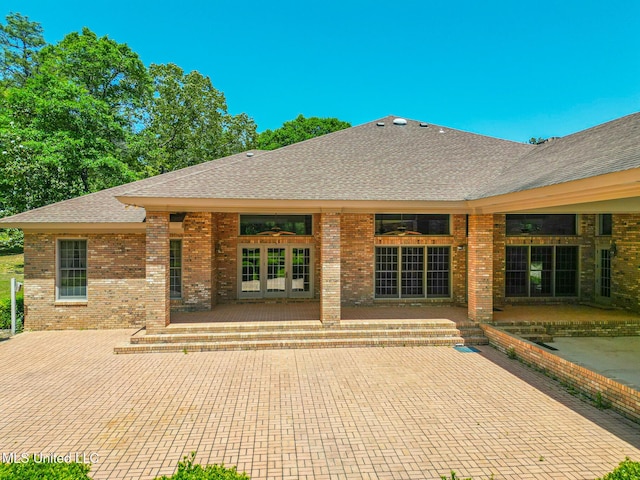 41 C G Evans Rd, Wiggins, MS 39577 - rear view of property featuring brick siding, a patio area, and a shingled roof