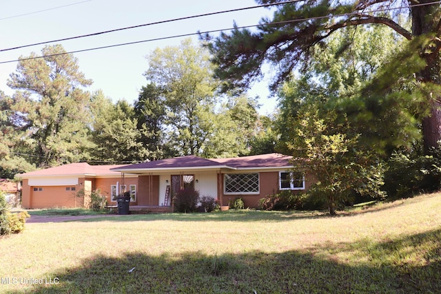 ranch-style house with a front yard and a garage