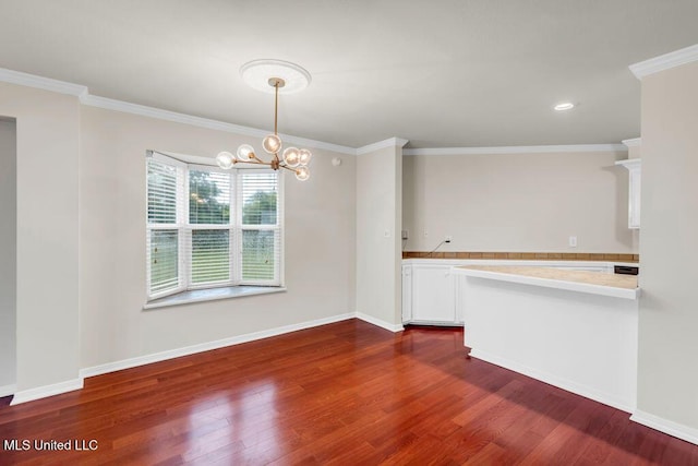 unfurnished dining area featuring dark wood-style floors, a chandelier, ornamental molding, baseboards, and recessed lighting