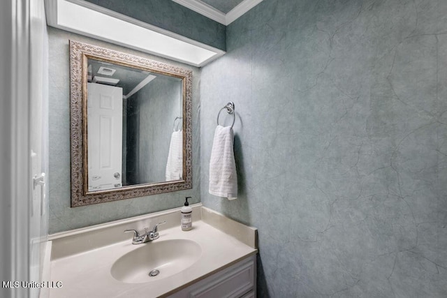 bathroom with ornamental molding and vanity