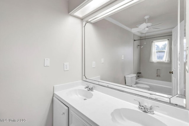 full bathroom with ceiling fan, toilet, shower / washtub combination, double vanity, and crown molding