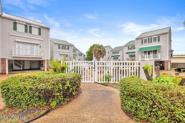 surrounding community with a residential view, fence, and a gate