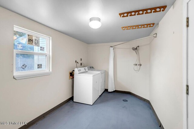 laundry room featuring separate washer and dryer and baseboards