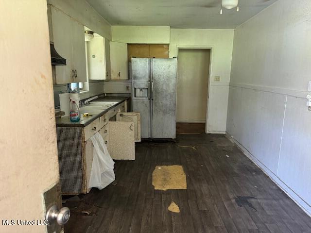 205 Hillside Dr, Vicksburg, MS 39180 - kitchen with a wainscoted wall, dark countertops, dark wood-type flooring, a sink, and white fridge with ice dispenser