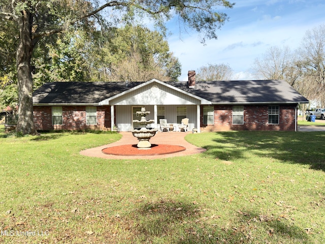 back of house featuring a lawn