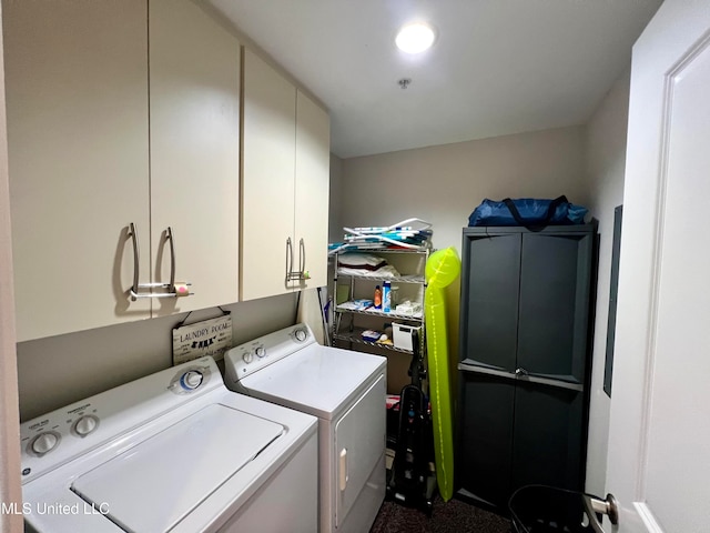 washroom with cabinets and washing machine and clothes dryer