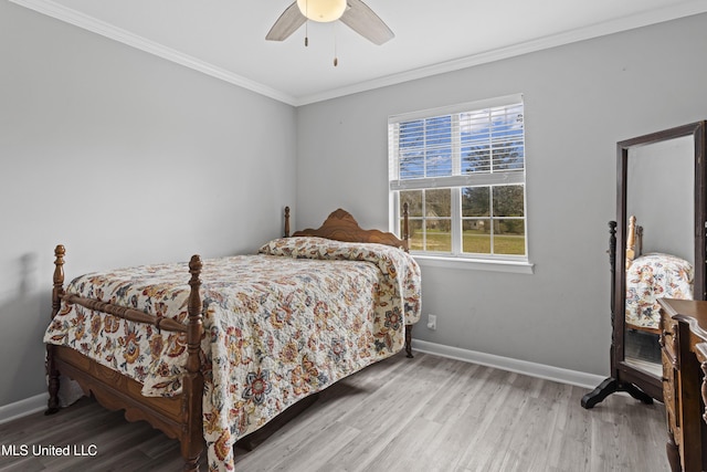 bedroom featuring ceiling fan, crown molding, baseboards, and wood finished floors