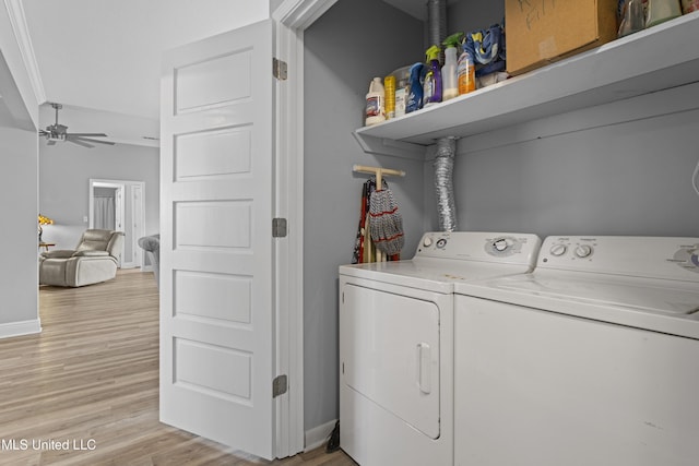 laundry area with light wood finished floors, washing machine and clothes dryer, ceiling fan, laundry area, and baseboards