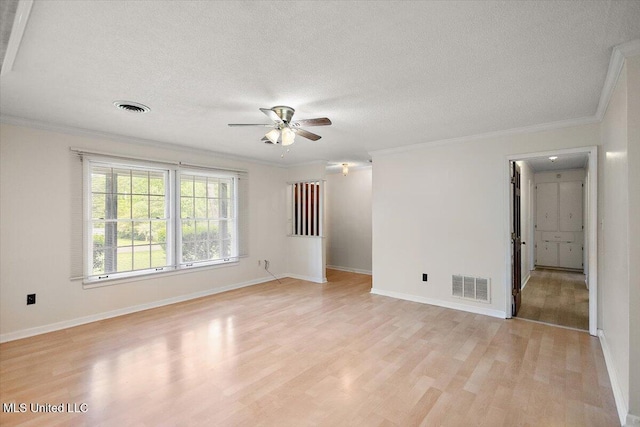 244 Massey Cir, Carthage, MS 39051 - unfurnished room featuring light wood-style floors, a ceiling fan, crown molding, a textured ceiling, and baseboards