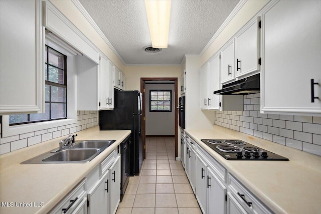 244 Massey Cir, Carthage, MS 39051 - kitchen with a sink, black appliances, under cabinet range hood, a textured ceiling, and light countertops