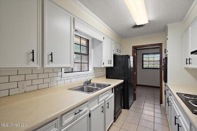 244 Massey Cir, Carthage, MS 39051 - kitchen featuring a sink, black appliances, backsplash, light countertops, and light tile patterned floors