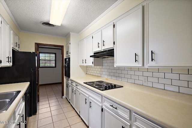 244 Massey Cir, Carthage, MS 39051 - kitchen with black appliances, under cabinet range hood, decorative backsplash, a textured ceiling, and white cabinetry