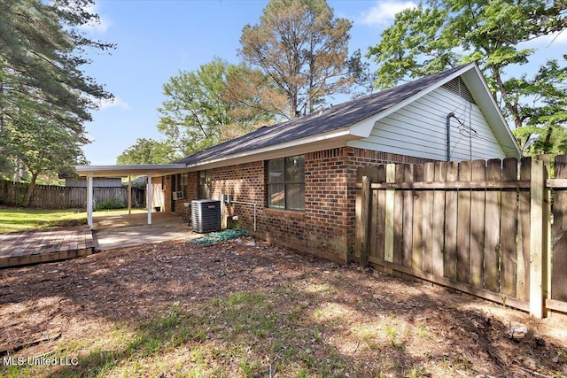244 Massey Cir, Carthage, MS 39051 - view of home's exterior featuring brick siding, central AC, and a patio area
