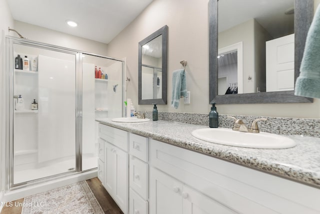 14172 Debra Barbee Ct, Gulfport, MS 39503 - bathroom with a shower stall, double vanity, and wood finished floors