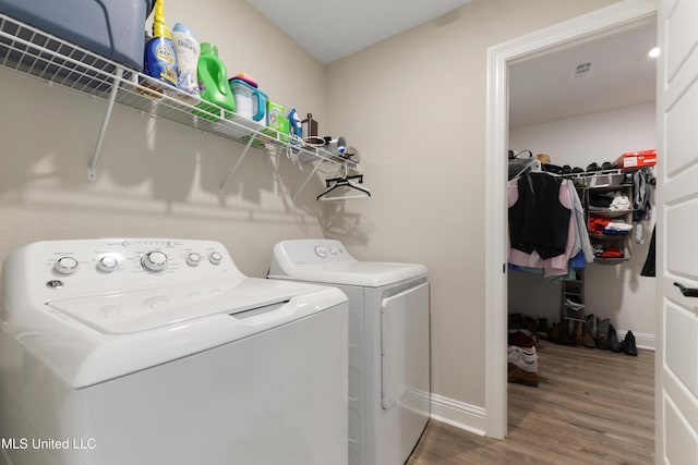 14172 Debra Barbee Ct, Gulfport, MS 39503 - laundry room featuring separate washer and dryer, wood finished floors, and baseboards