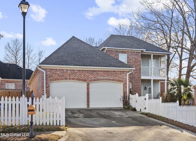 front facade featuring a garage and a balcony